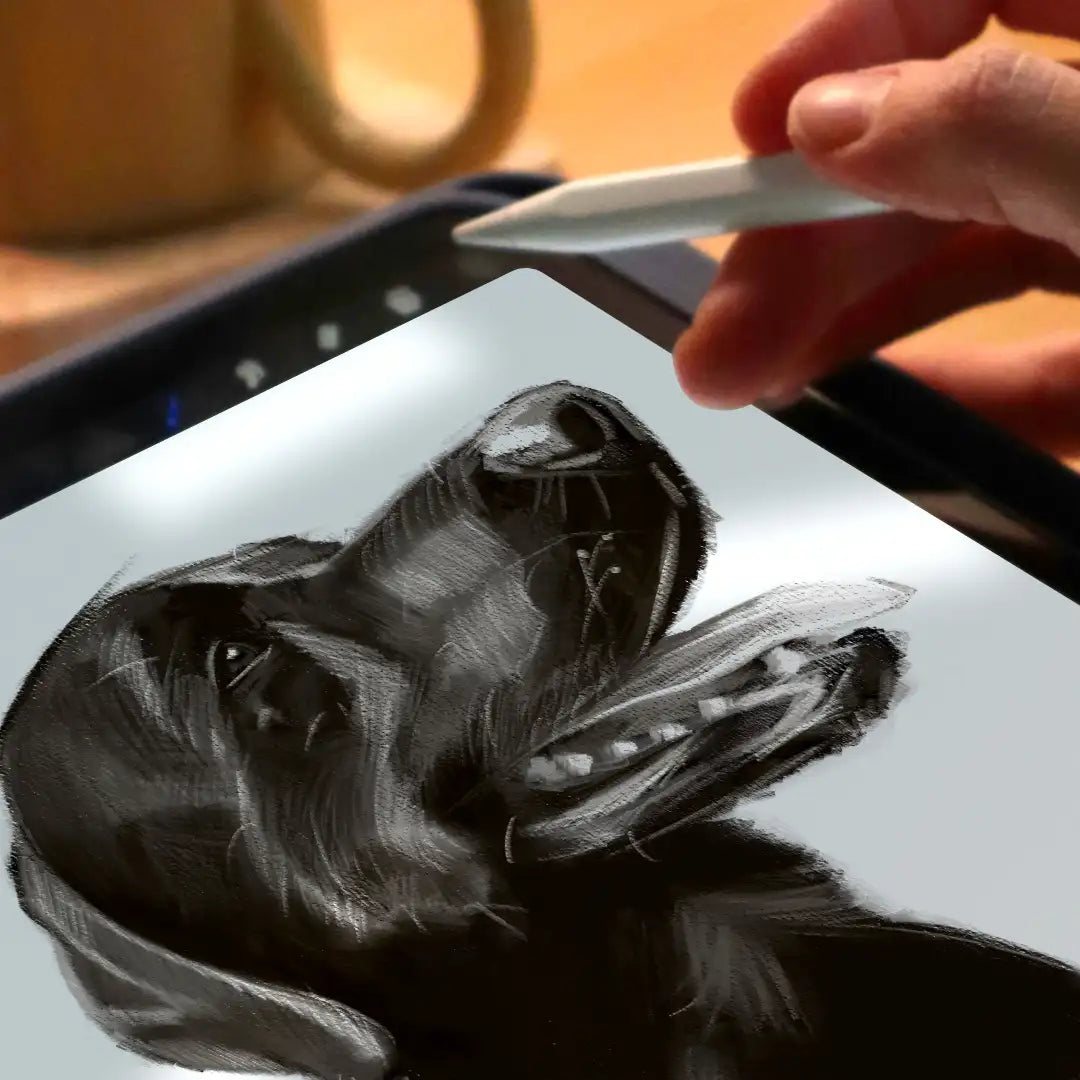Artist’s hand holding a stylus above a digital tablet while drawing a pencil-style portrait of a black Labrador in a cosy home setting.