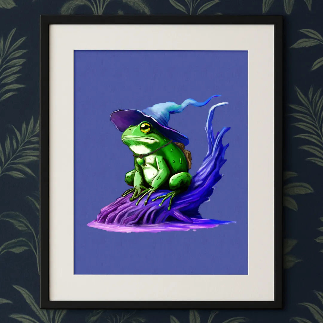 Framed Wizarding Frog Fantasy Print hung on a vibrant 70s jungle-themed wallpaper wall — playful, handmade eco art adding a touch of magic to your unique space.