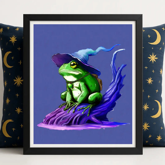 Wizarding Frog Fantasy Print framed in sleek black, styled against a navy 90s celestial pillow. This magical frog illustration depicts a from wearing a wizard hat, sat a burnt dead tree pocking out of a swamp. This piece is perfect for magical home decor.
