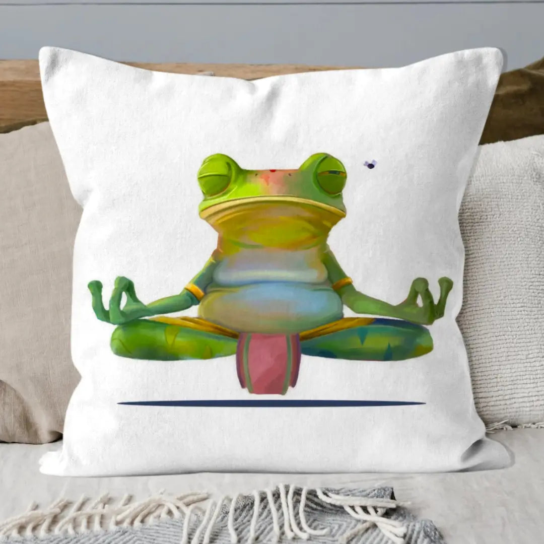 Meditating frog cushion styled on a bed with soft linen pillows and a beige throw, perfect for a calm, cosy bedroom space.