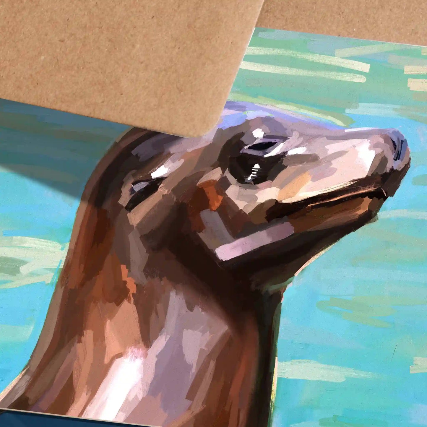Handmade eco-friendly greeting card featuring a surf-loving seal illustration, printed on sustainable paper with a blank inside. This close up image shocase the loose and vibrant bruishtrokes used to create the illustration giving off a beautiful painterly feel to the piece.
